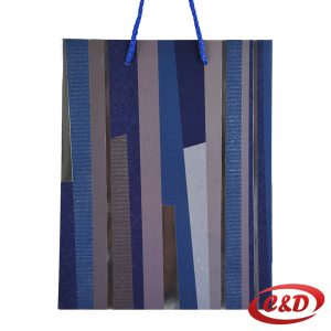 Plavo-siva poklon vrećica s modernim prugastim dizajnom i plavom ručkom.